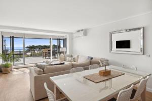 a living room with a couch and a table at Apartment 12 Pacific Apartments in Lorne