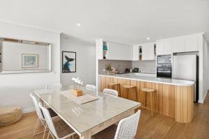 a dining room and kitchen with a table and chairs at Apartment 12 Pacific Apartments in Lorne