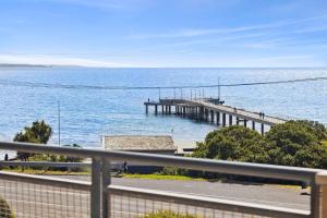 a pier in the water next to the ocean at Apartment 12 Pacific Apartments in Lorne