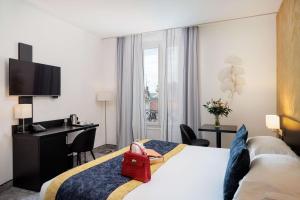 a hotel room with a bed and a desk at Best Western Plus Hôtel Massena Nice in Nice