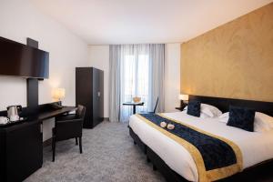 a hotel room with a large bed and a desk at Best Western Plus Hôtel Massena Nice in Nice