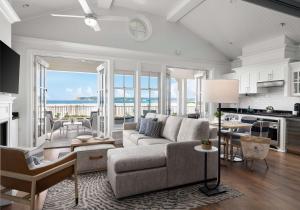 a living room with a couch and a kitchen with the ocean at Beach Village at The Del, Curio Collection by Hilton in San Diego