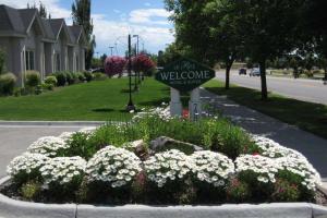 a welcome sign in a bed of flowers in a street at Le Ritz Hotel and Suites in Idaho Falls