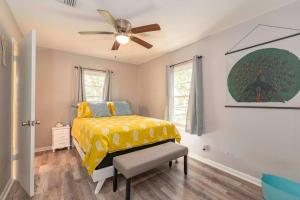 a bedroom with a yellow bed and a ceiling fan at Cozy & Quiet Lafayette Home in Lafayette