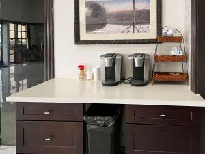 a kitchen counter with a coffee maker on it at Studio 6 Artesia CA in Artesia