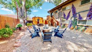 a group of blue chairs sitting in a yard at Downtown Cozy Home Base - Purple Sage 2 in Moab