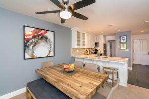 a kitchen and dining room with a wooden table at Ski in Ski out 2nd Floor Sweetly Updated Condo in Telluride