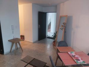 a living room with a table and a black door at Apartaestudio Edificio Marianna - Sector Buenavista in Barranquilla