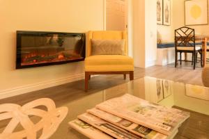 a living room with a fireplace and a chair at Maleny Hotel in Maleny