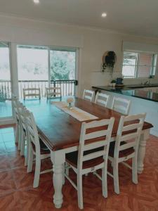 a dining room with a wooden table and chairs at Downing Estate Homestead in Heathcote