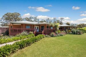 a house with a lawn in front of it at Downing Estate Homestead in Heathcote