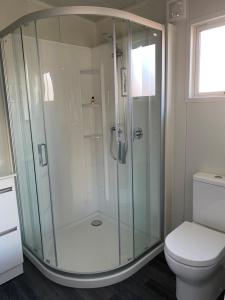 a glass shower in a bathroom with a toilet at Haven On Tau in Ohakune