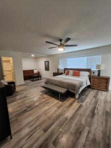 a bedroom with a bed and a ceiling fan at Pampas House in Las Vegas