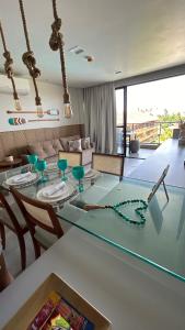 a glass table in a living room with chairs and a tableablish at Eco resort Praia dos Carneiros in Praia dos Carneiros
