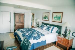 a bedroom with a large bed and a wooden dresser at Beach Front/Free Breakfast/Hawaiian Retreat/Luxury in Hauula