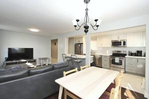 a living room with a couch and a table at Barrie House near to all amenities in Barrie