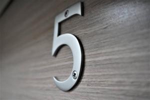 a metal number on a wooden surface at Queens Luxury Apartments Wembley Stadium - London in London