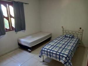 Llit o llits en una habitació de Casa Rio das Ostras
