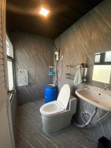a bathroom with a toilet and a sink and a tub at Little Farm Nakornnayok 