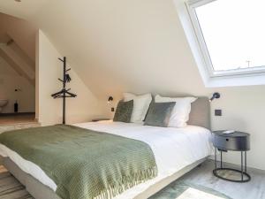 a bedroom with a large bed with a large window at Luxury holiday home in Kortrijk with wellness and heated pool in Kortrijk