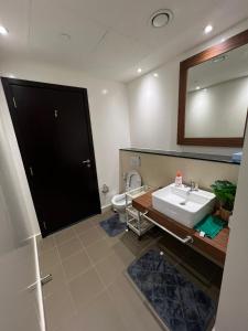 a bathroom with a sink and a toilet at Lodges in Al Ain