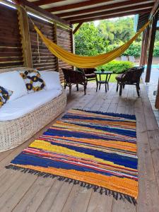 a porch with a hammock and a rug at Villa Tourmaline in Le Lorrain