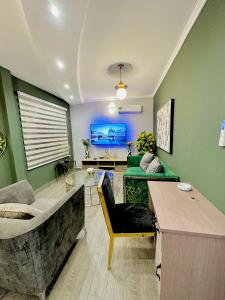 a living room with a couch and a table at The Jumeirah Guest Home in Yaoundé