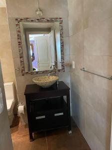a bathroom with a sink and a mirror at casa de campo in Punta Indio