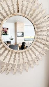 a mirror hanging on a wall in a living room at Shack on the Bay - A Lovely Bayside Cabin in Strahan