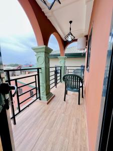 a balcony on a cruise ship with a chair at The Jumeirah Guest Home in Yaoundé