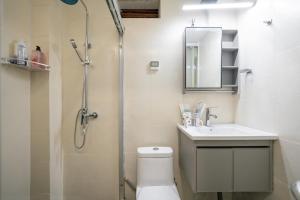 a bathroom with a shower and a toilet and a sink at Shanghai Downtown Yidu B&B - Near South Shaanxi Road Metro Station in Shanghai