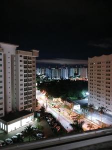 a view of a city at night with tall buildings at Condomínio cesars park flats in Caldas Novas