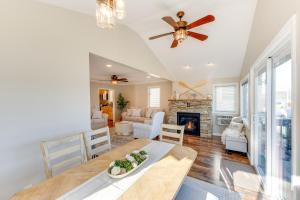 a living room with a dining table and a fireplace at Lakefront Highland Home with Dock about 2 Mi to Milford! 