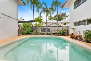a swimming pool in the backyard of a house at Oliva St 2 Bedroom Palm Cove Apartment in Palm Cove
