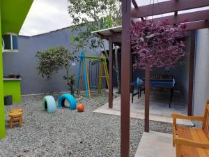 a backyard with a play area with a playground at Morada das Marés - Balneário Barra do Sul in Balneario Barra do Sul