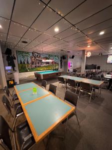 a conference room with ping pong tables and chairs at Minnedosa Inn in Minnedosa