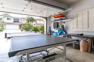 a ping pong table in the middle of a room at Carlsbad Dream House with Hot Tub Walk to Beach in Carlsbad