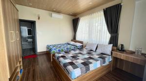 Postel nebo postele na pokoji v ubytování Homestay Chân Quê