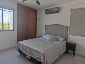 a bedroom with a bed and a window at CASA ENTERA 3 HABITACIONES 10 PERSONAS in Caucel