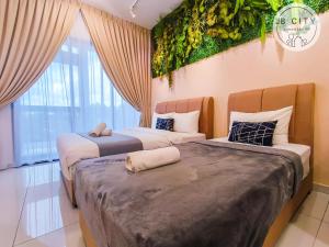 two beds in a room with plants on the wall at Sky Tree by JBcity Home in Johor Bahru