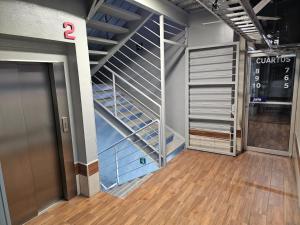 a walk in closet with a staircase in a building at Hotel Sttiny Monterrey Tecnológico in Monterrey