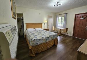 a hotel room with a bed and a window at Rodeway Inn Fort Pierce US Highway 1 in Fort Pierce