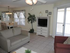 a living room with a couch and a television at Golf Resort Villa 2607 with Outdoor Pool in Calabash