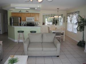 a living room with a couch and a kitchen at Golf Resort Villa 2607 with Outdoor Pool in Calabash