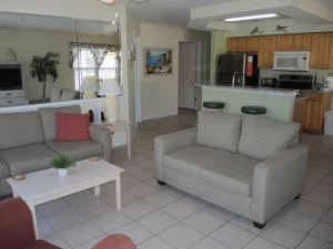 a living room with two couches and a kitchen at Golf Resort Villa 2607 with Outdoor Pool in Calabash
