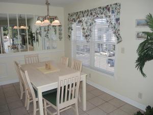 a dining room with a white table and chairs at Golf Resort Villa 2607 with Outdoor Pool in Calabash