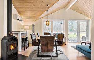 a living room with a wood stove and a dining room at 3 Bedroom Stunning Home In Give in Give