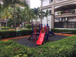 a playground in front of a building with palm trees at Seanest Residence 贤巢民宿 18 "Owned by Amadel Residence" in Melaka