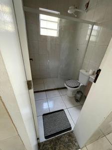 uma casa de banho com um chuveiro e um WC. em Casa Pelinca 1 quarto em Campos dos Goytacazes