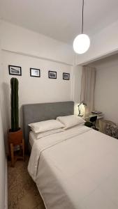 a bedroom with a large white bed and a lamp at Room at Centro Histórico in Mexico City